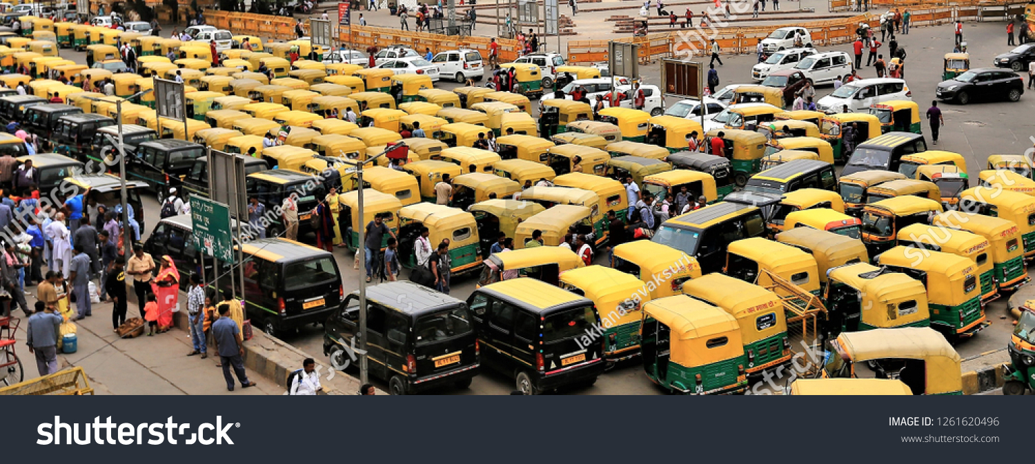 stock-photo-delhi-india-aug-a-yellow-indian-tricycle-is-parked-in-the-courtyard-to-wait-for-passengers-1261620496.jpg